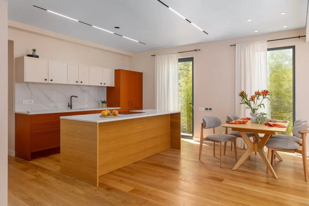 Modern kitchen and dining area with wood island and table