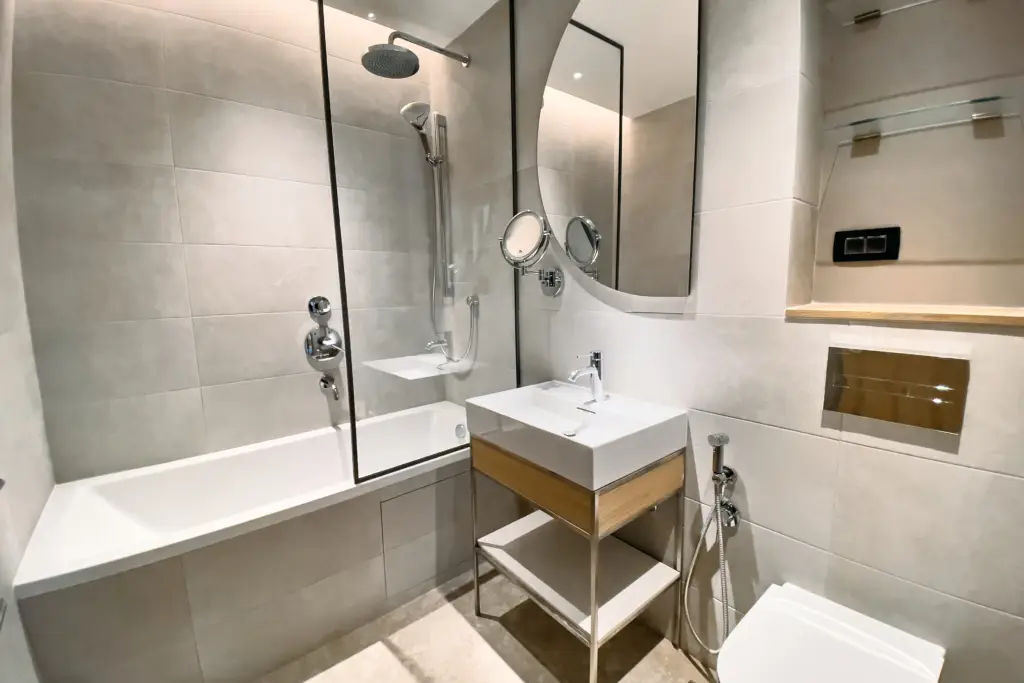 Modern bathroom with bathtub, glass shower, and sink vanity