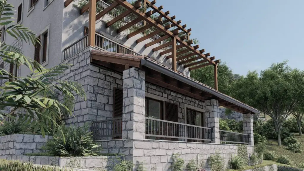 Stone house with pergola balcony and surrounding greenery
