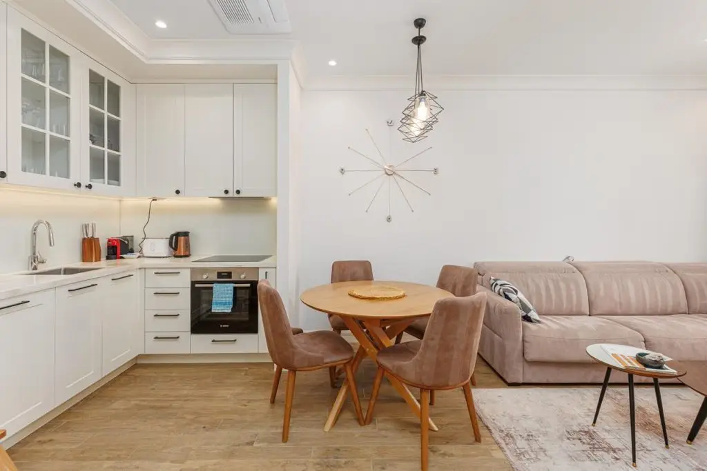 Modern open-plan kitchen and living room with round dining table