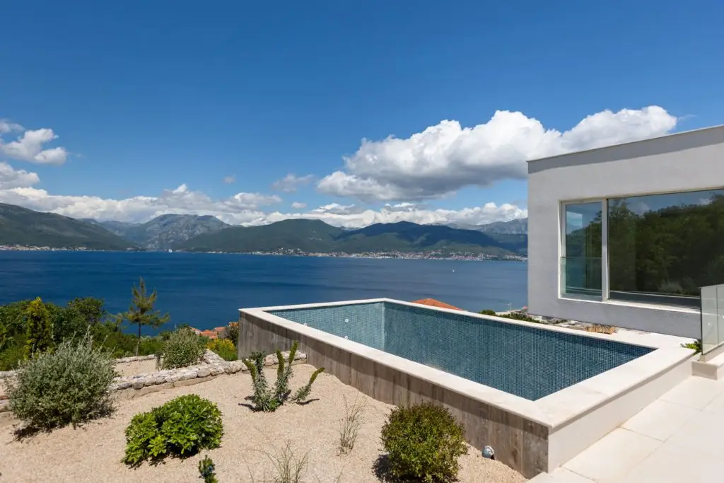 Modern villa with infinity pool overlooking the sea and mountains