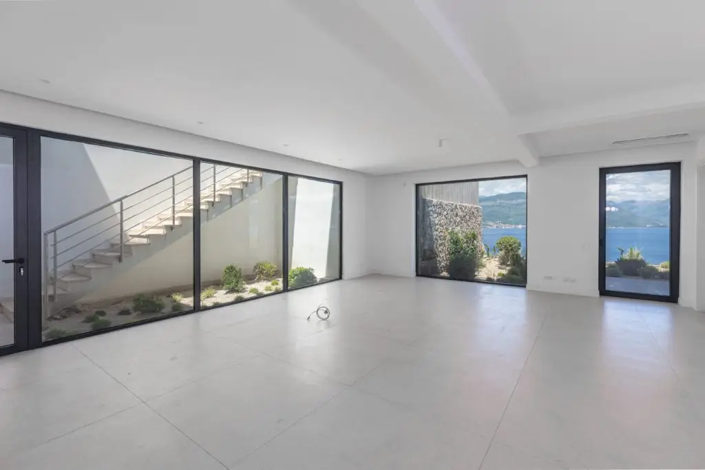 Empty modern room with large windows and sea view