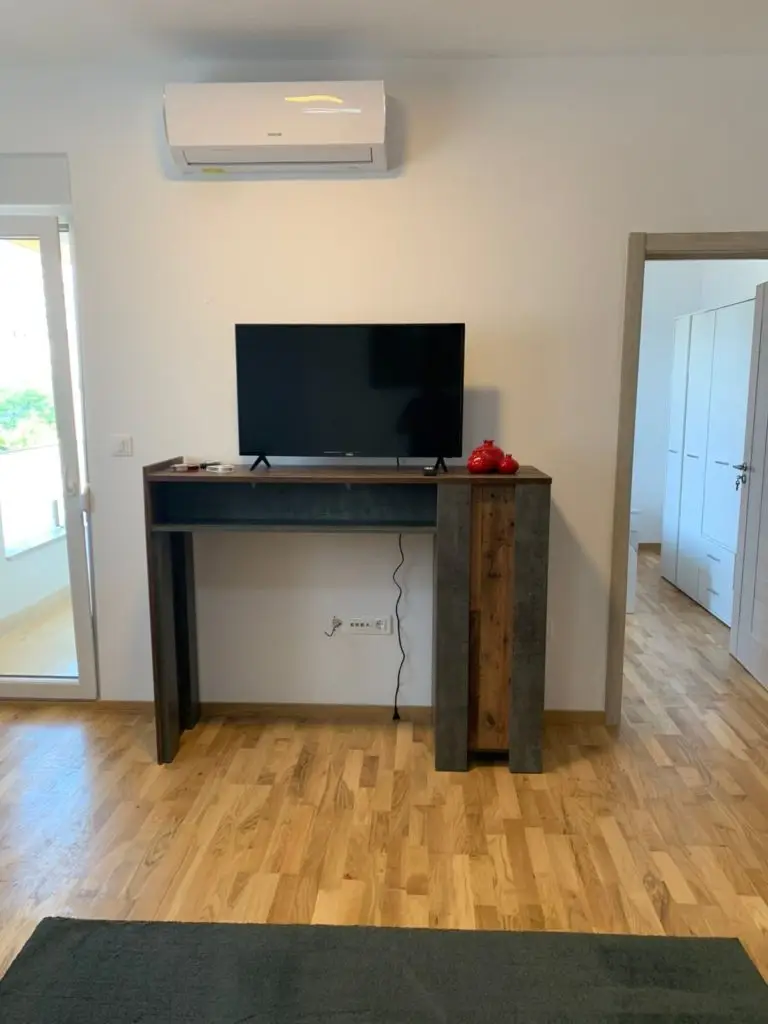 Living room with TV console and wall-mounted air conditioner