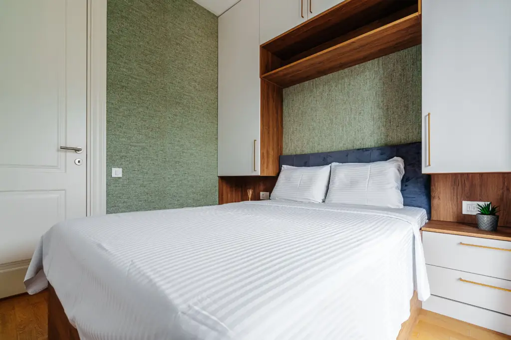 Modern bedroom with white bed and built-in cabinets