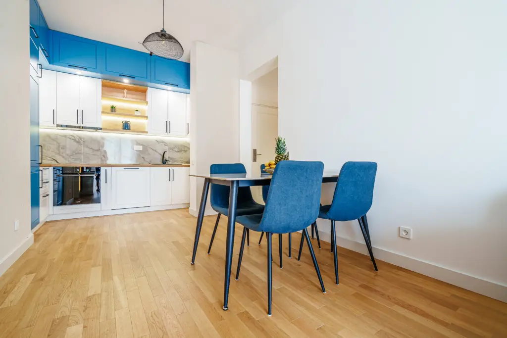 Modern kitchen and dining area with blue chairs