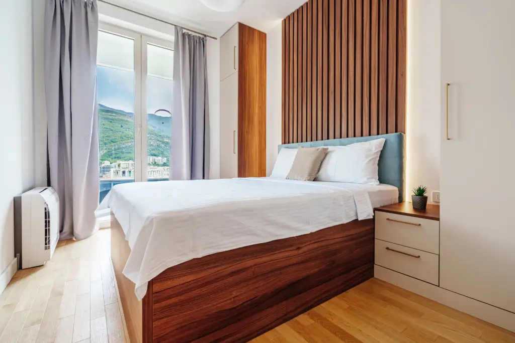 Modern bedroom with bed, window, and mountain view