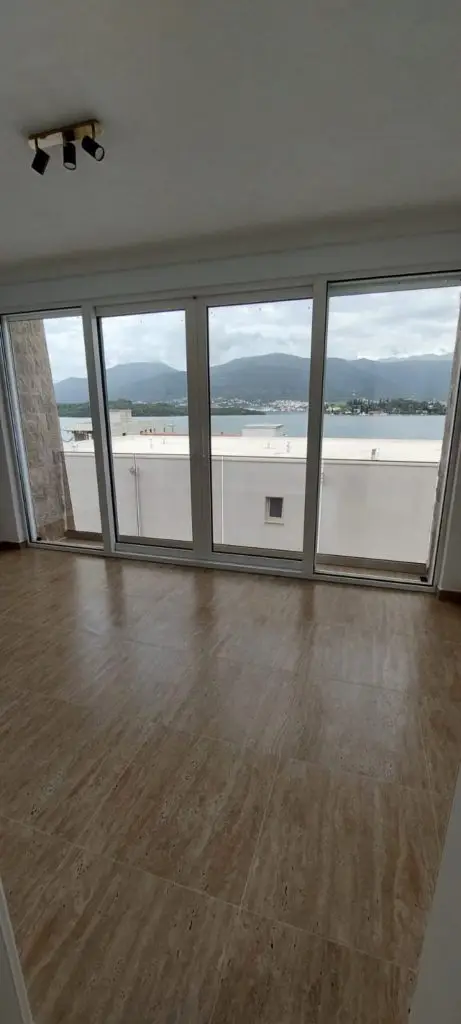 Empty room with sliding glass doors and sea view