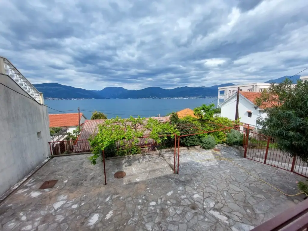 Stone terrace with pergola overlooking sea and mountains