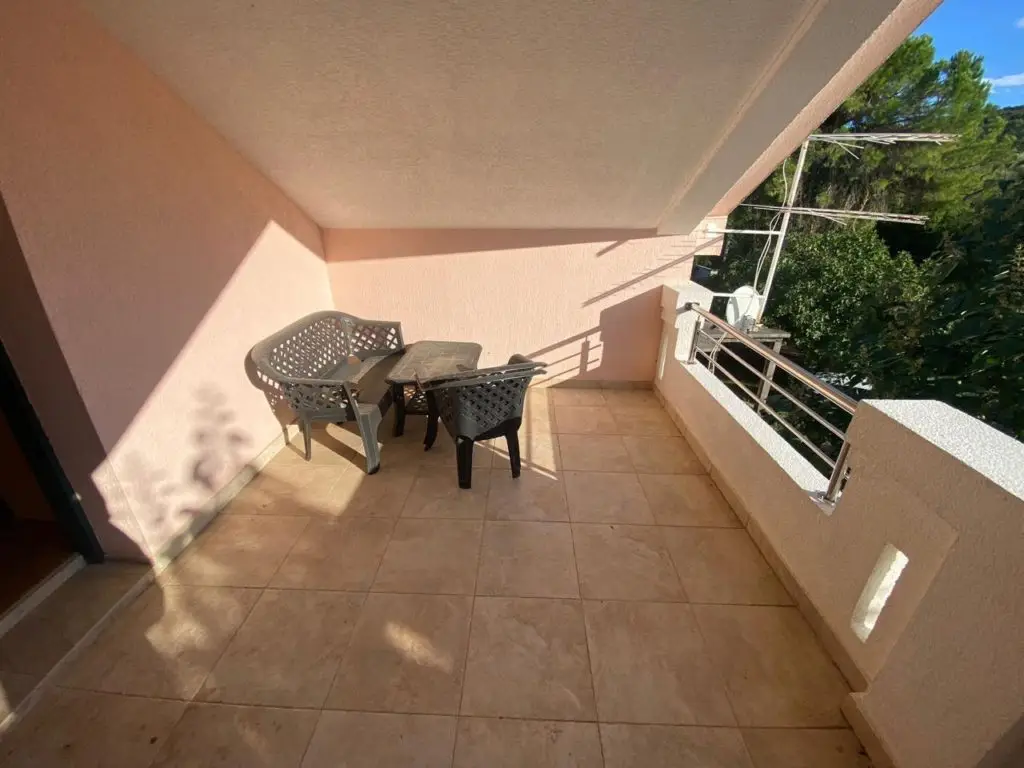 Balcony terrace with two chairs, table, and railing