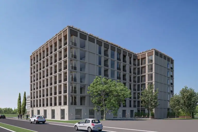 Modern gray apartment building with trees and cars