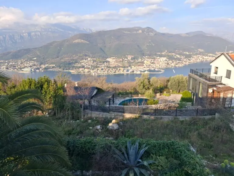 Hilltop house and pool overlooking bay and mountains