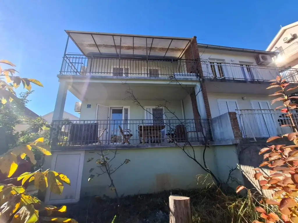 Three-story house with balconies and a covered terrace