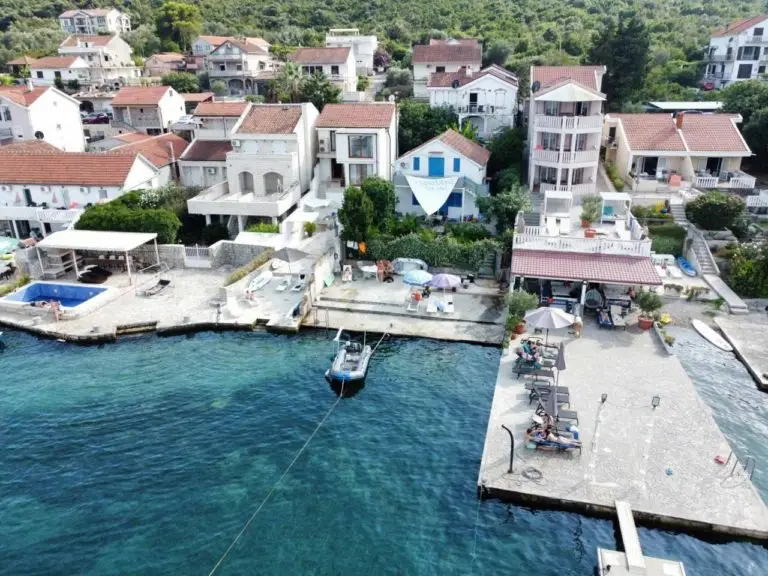 Aerial view of seaside houses with docks and boat
