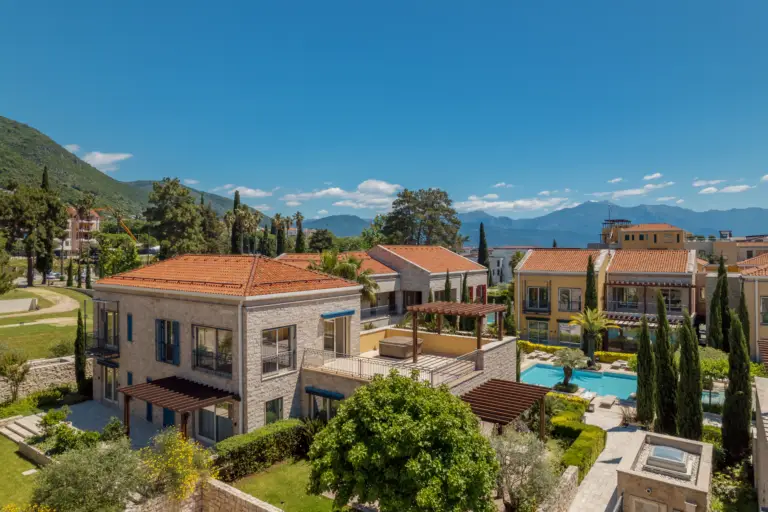 Mediterranean-style villas with pool, mountains and sea in background