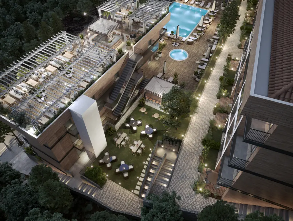 Aerial view of apartment courtyard with pools and lounge chairs