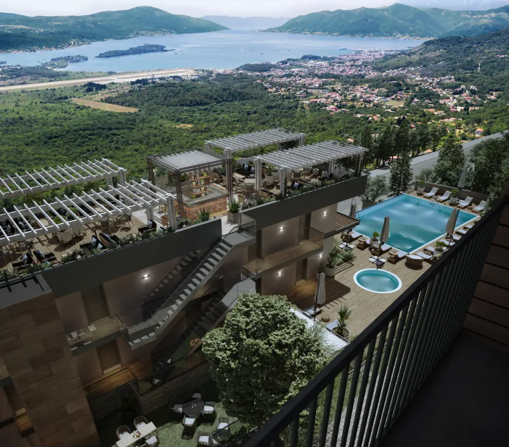Rooftop terrace with pool overlooking a bay and mountains