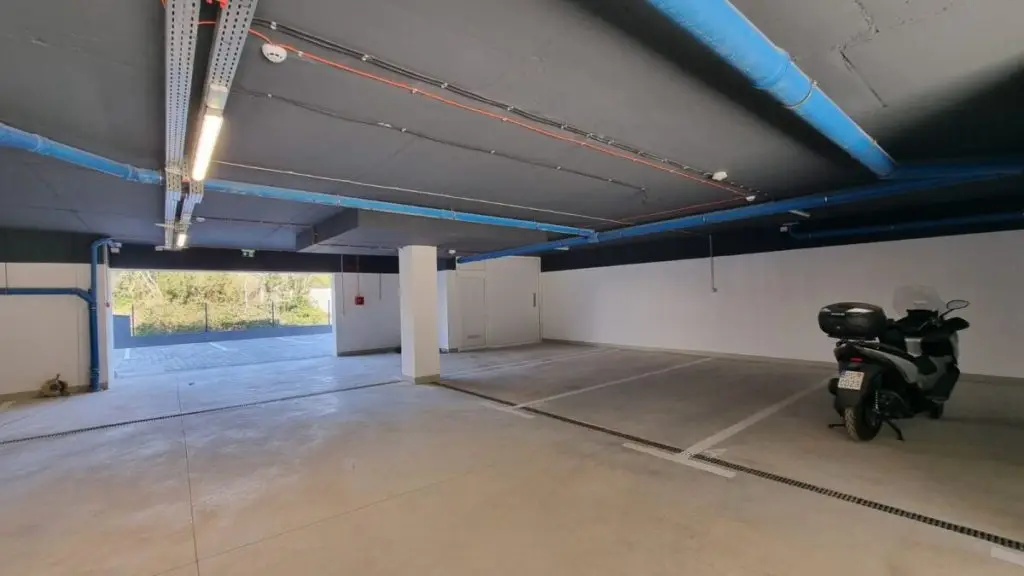 Indoor parking garage with parked black scooter