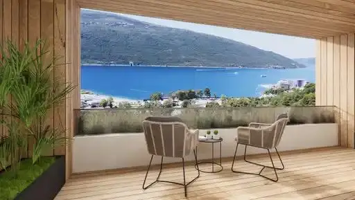 Modern terrace with two chairs overlooking the sea and mountains