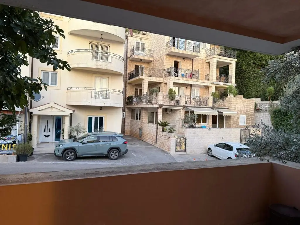 Balcony view of apartment buildings with parked cars