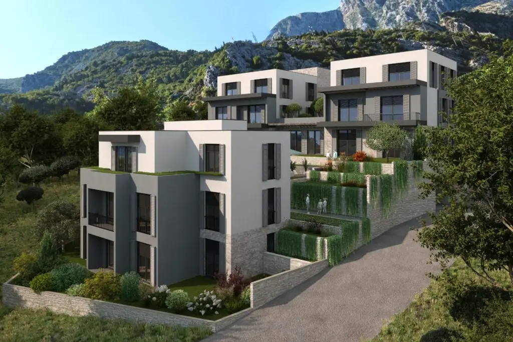 Modern apartment buildings on a green mountainside