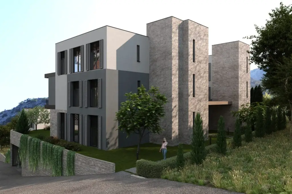 Modern apartment building with stone towers and greenery