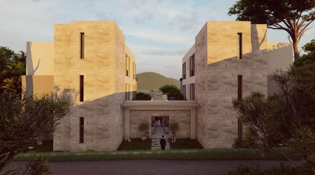 Modern stone apartment buildings with central entrance and trees