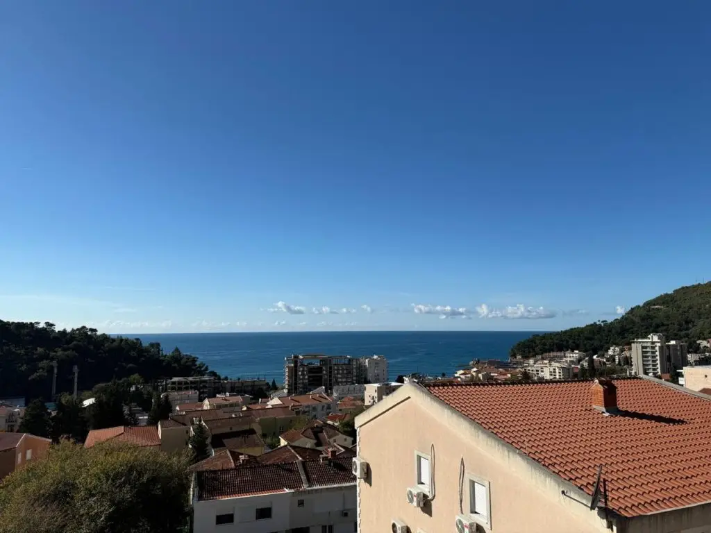 Coastal town rooftops with sea and blue sky view