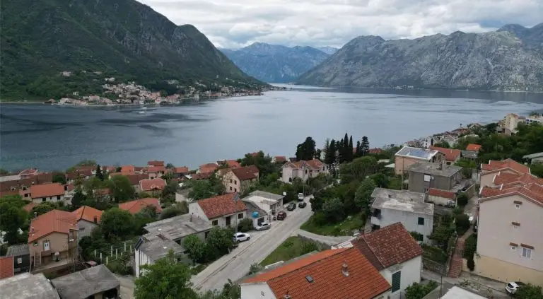Hillside coastal village overlooking a bay and mountains