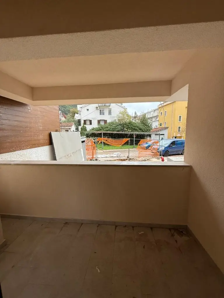 Covered balcony overlooking construction site and street