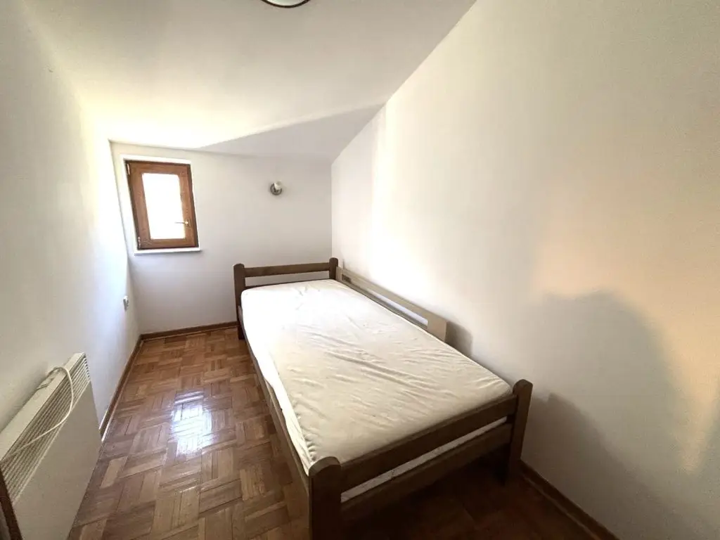 Small bedroom with single bed, window, and radiator