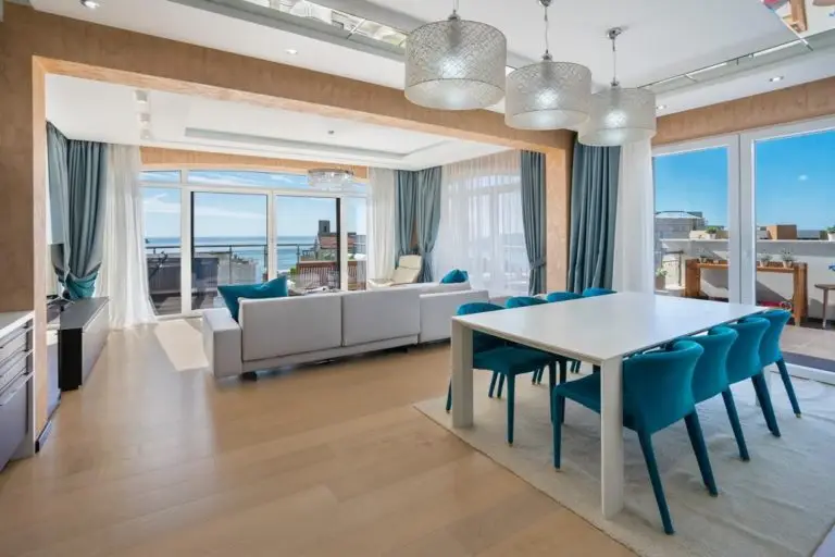 Modern living and dining room with sea view balcony