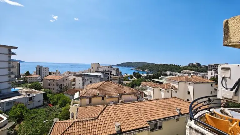 Balcony view over rooftops toward the sea