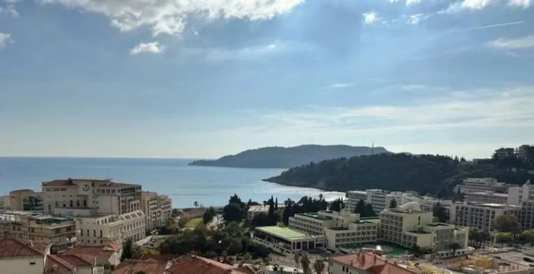 Panoramic sea view over coastal buildings and hills