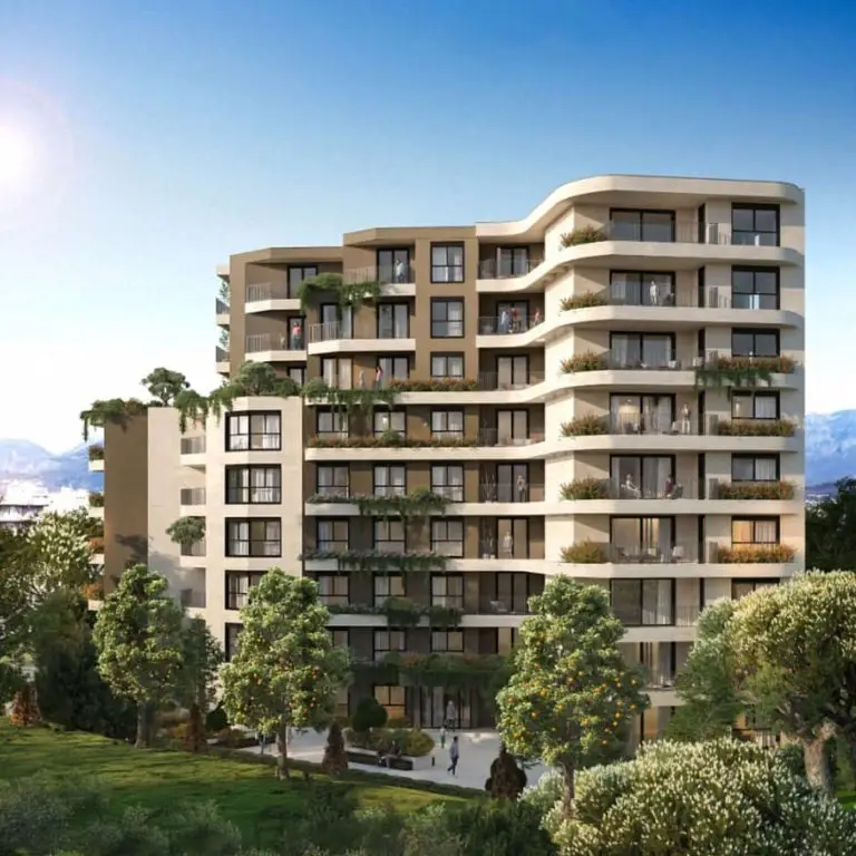 Modern apartment building with balconies and landscaped trees