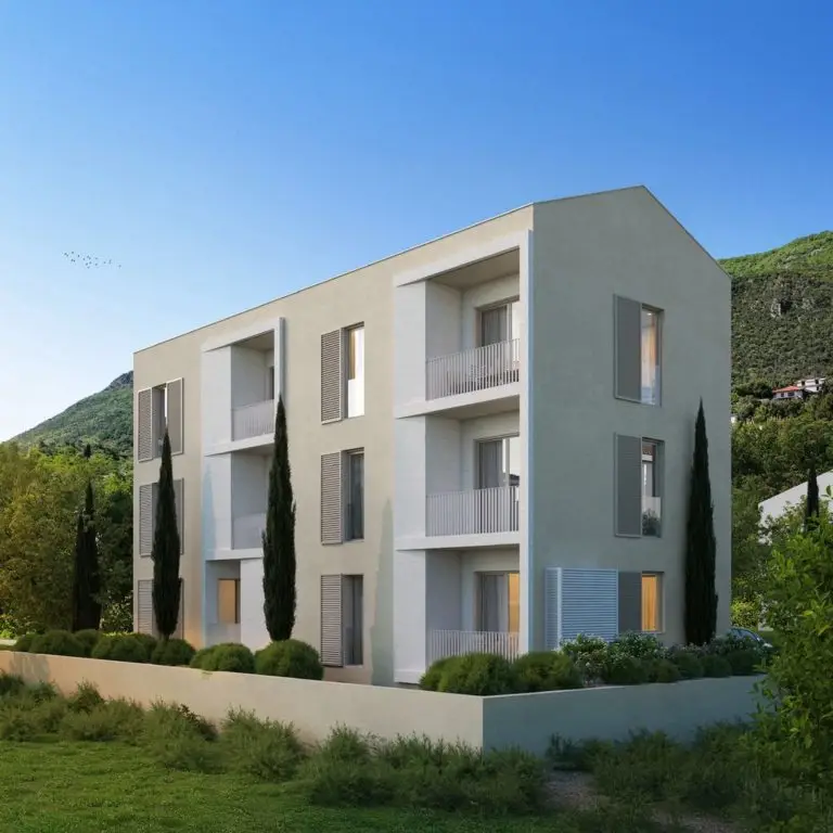 Modern beige three-story apartment building with balconies and shutters