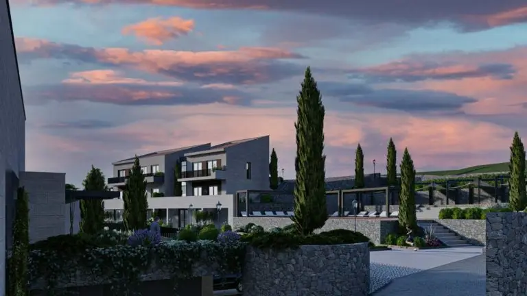 Modern apartment complex with pool and cypress trees at dusk
