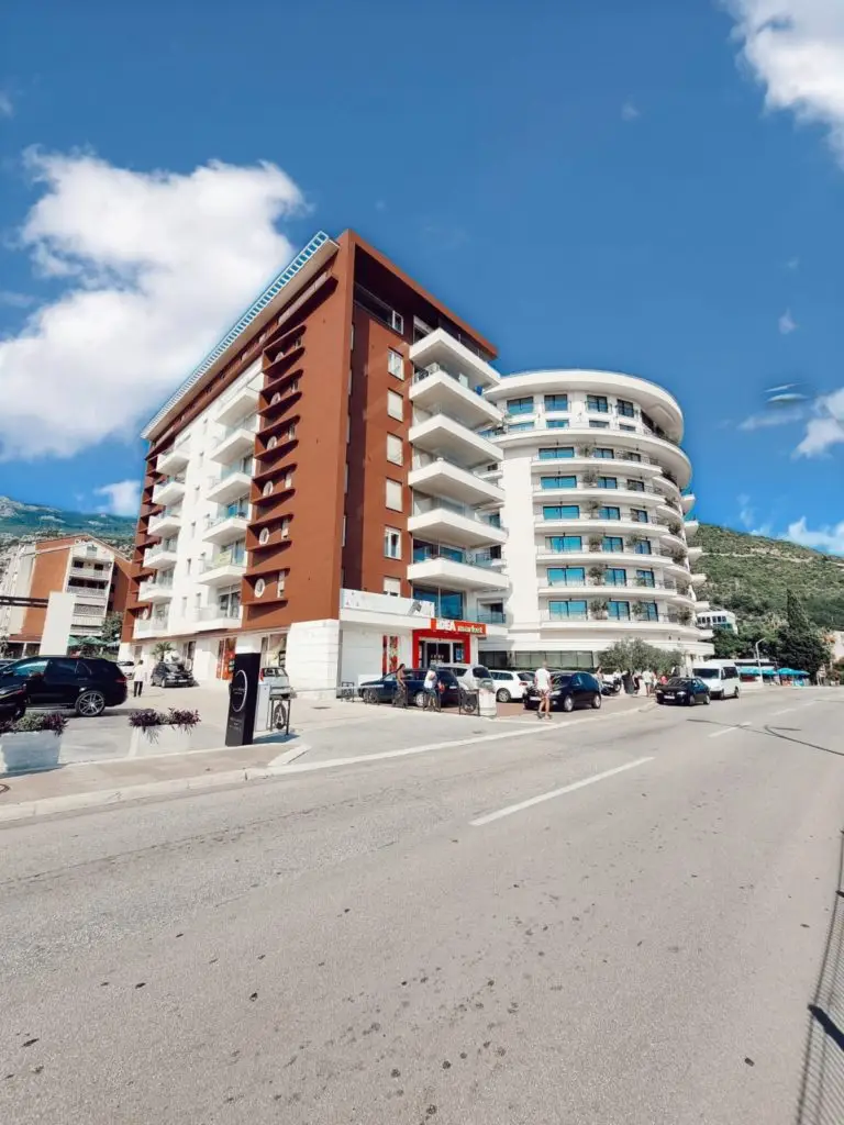 Modern apartment building with IDEA market storefront and balconies