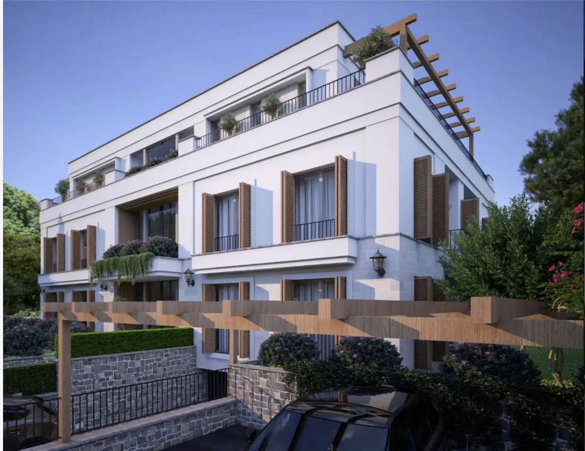 Modern white apartment building with balconies and wooden shutters
