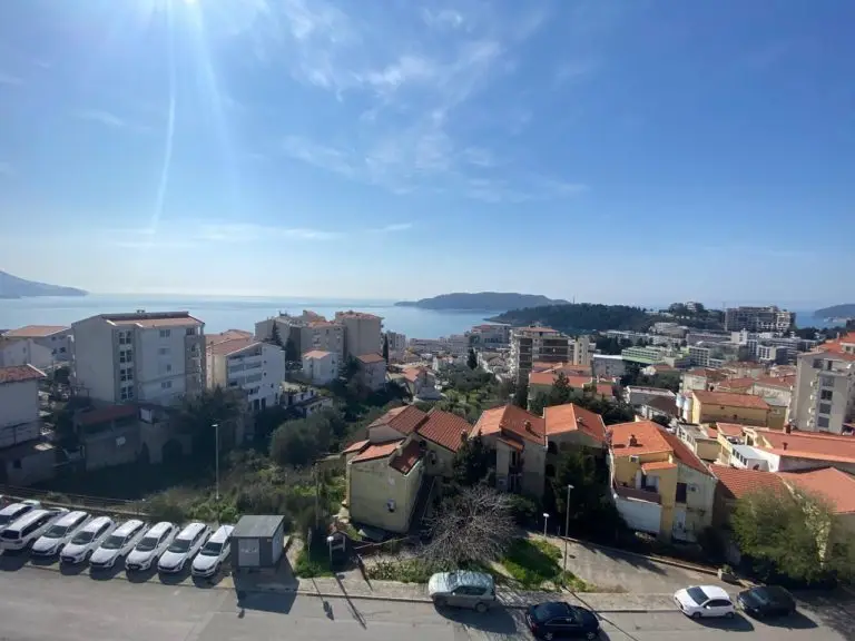 Coastal town with sea view and red-roofed buildings