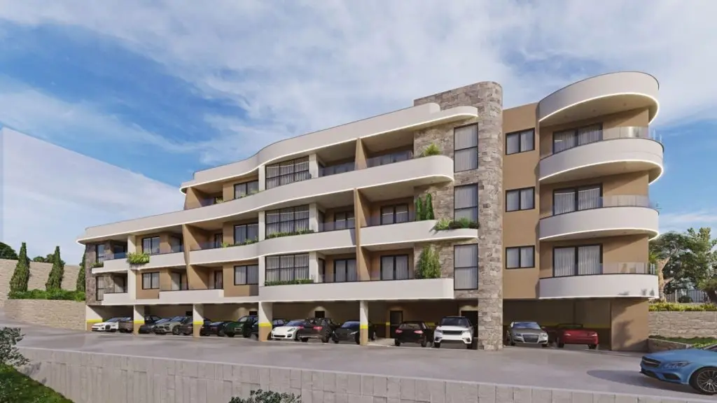 Modern apartment building with curved balconies and parked cars