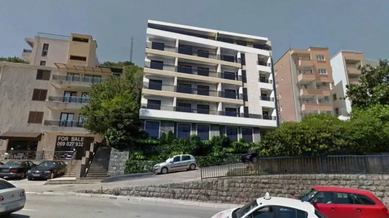 Modern apartment buildings with a FOR SALE sign